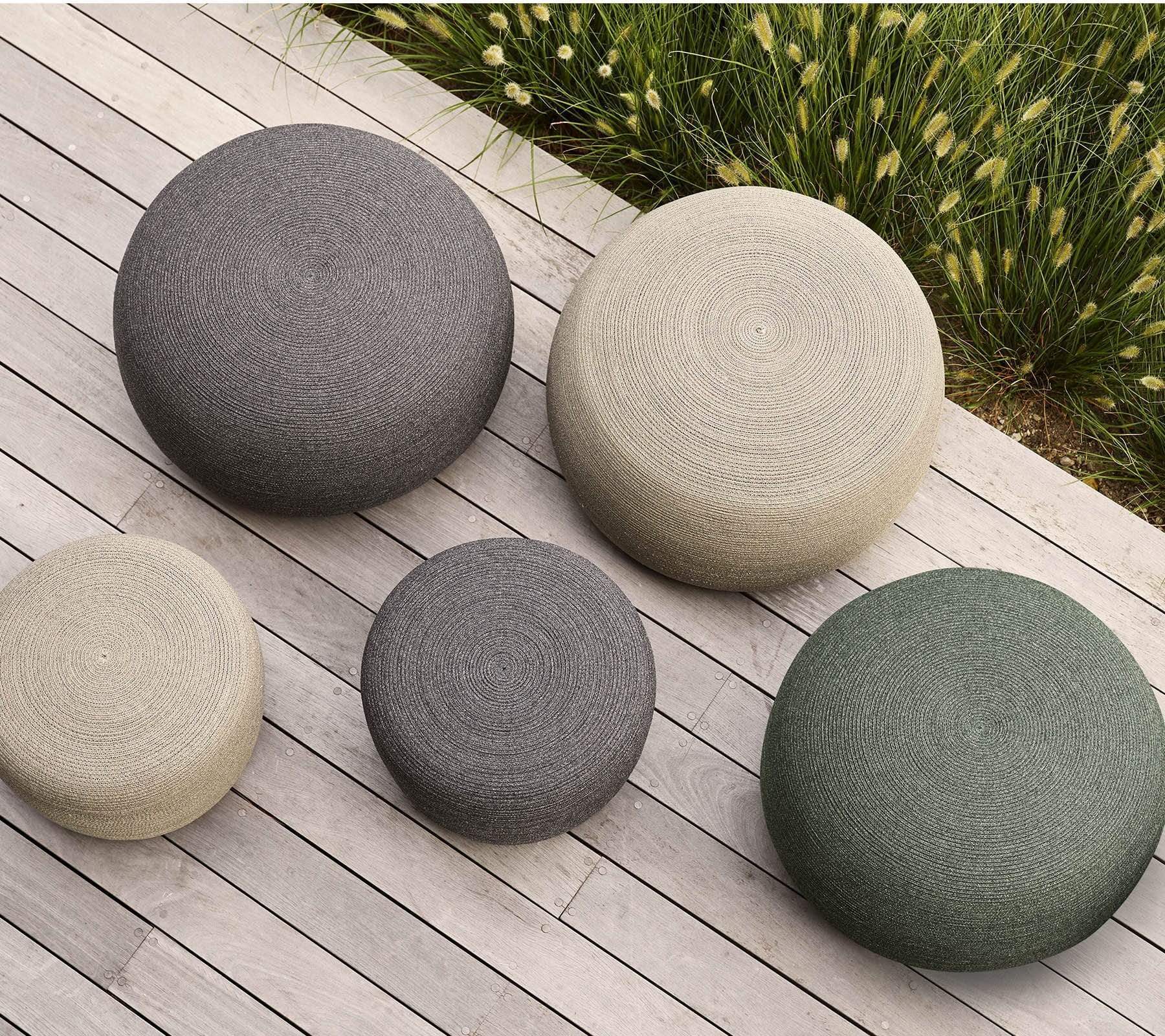 Boxhill's dark green, taupe and dark grey outdoor round large soft rope footstool with small size placed on wooden platform