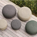 Boxhill's dark green, taupe and dark grey outdoor round large soft rope footstool with small size placed on wooden platform