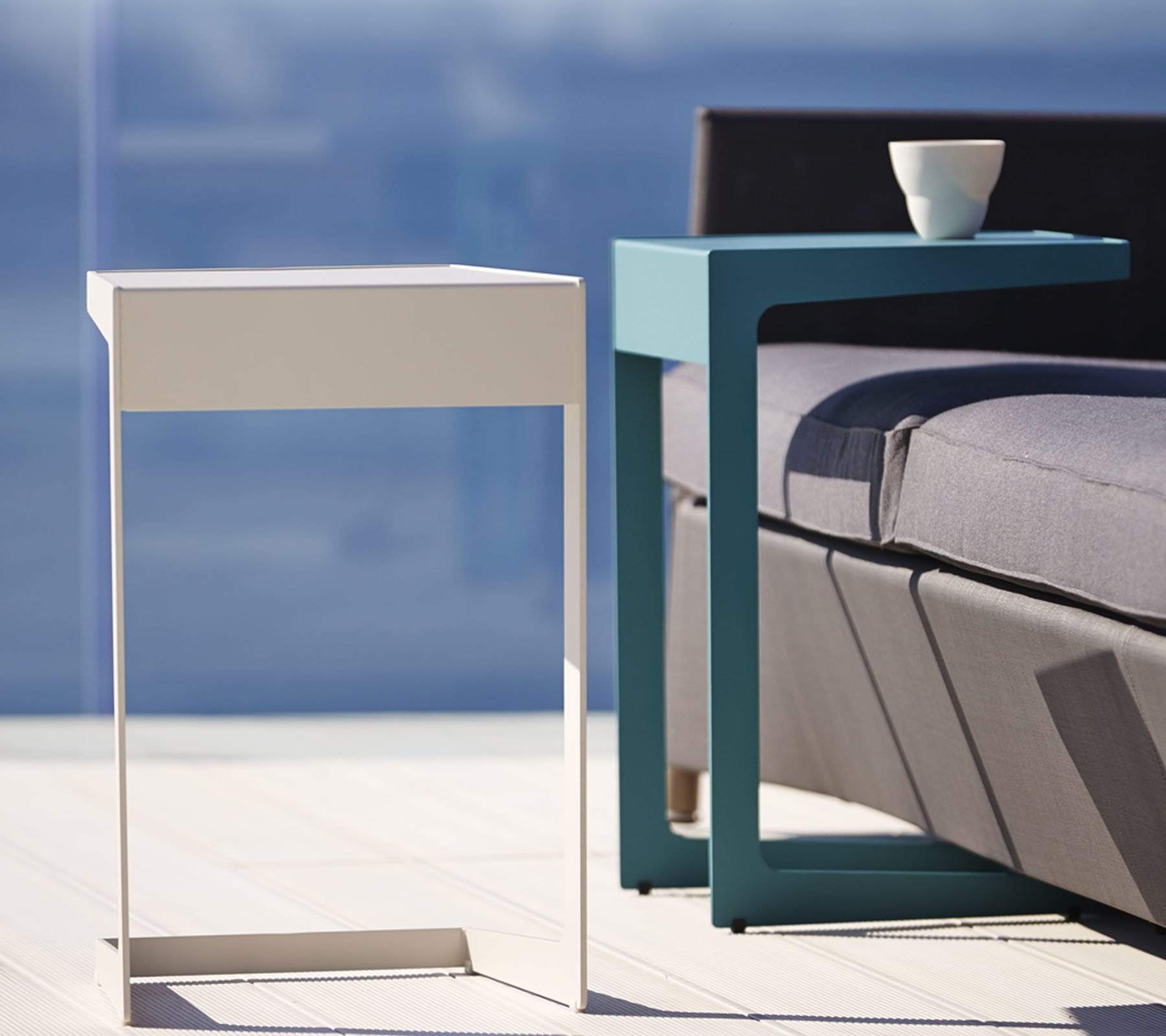 Boxhill's Time-Out white and aqua green outdoor side table placed beside grey outdoor sofa