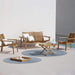 Boxhill's Amaze 2-Seater Teak Sofa lifestyle image with amaze lounge chair beside the pool