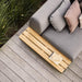 Boxhill's Space light grey outdoor 2-seater sectional sofa with teak side table top with pillows set on wooden platform