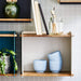 Boxhill's blue / white Wall-mounted Teak Wood Square Shelves mounted on grey wall tiles with random things on it